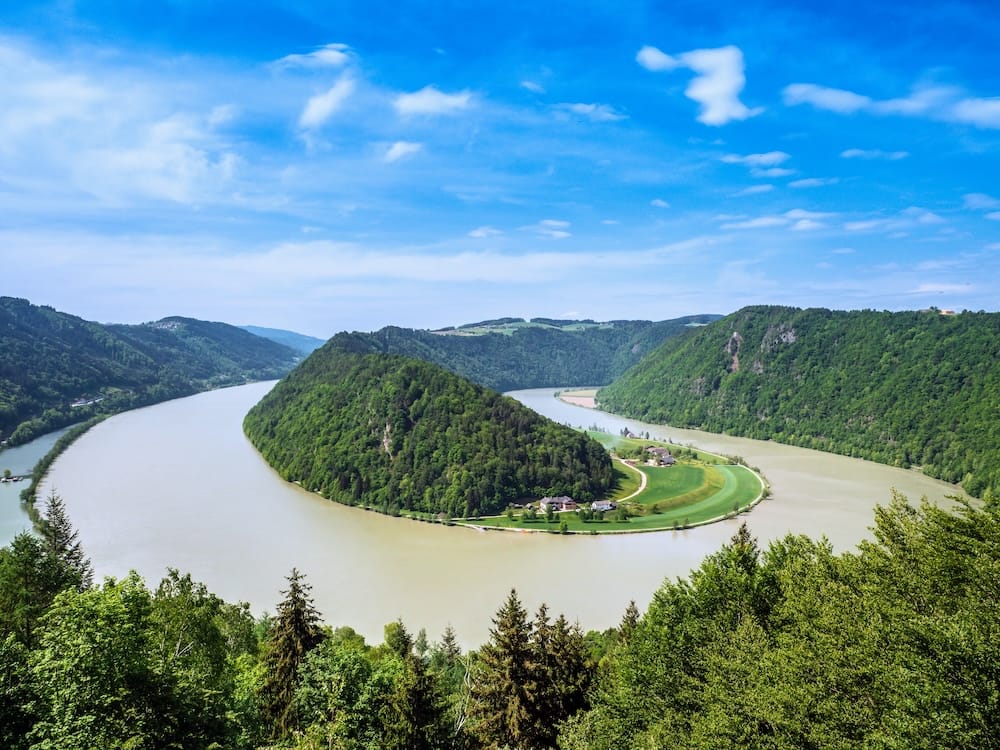 Schlögener Schlinge - Donautal High-angle panoramic view of the Schlögener Schlinge (Schlögen Bend) where the Danube River loops dramatically around a forested peninsula in Upper Austria